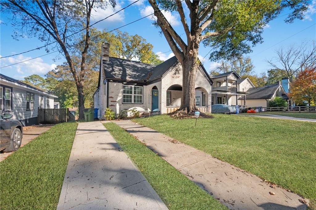 880 Westmont Road Southwest Atlanta, GA 30311 - Photo 1 of 1 a front view of a house with a garden and trees