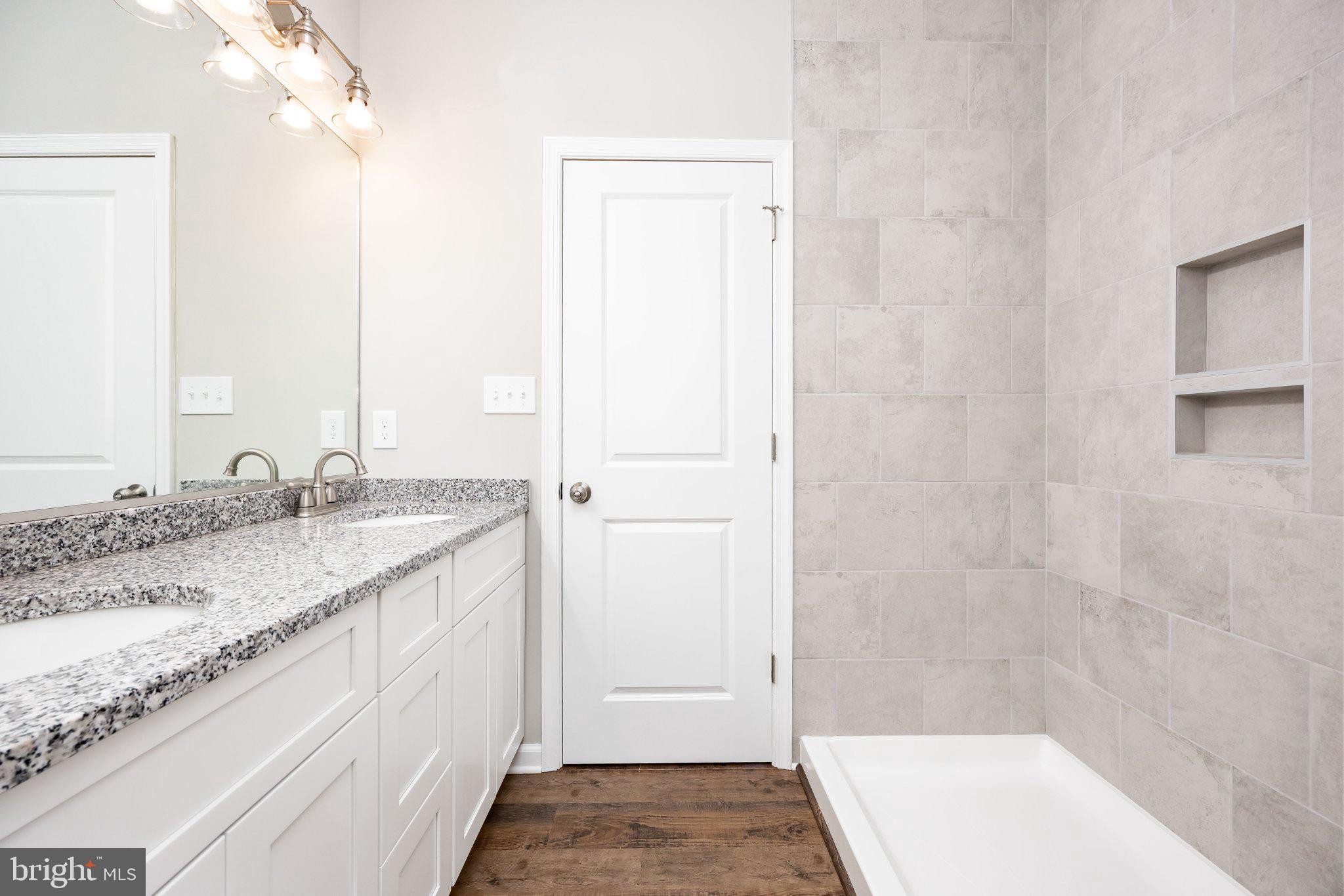 14949 Shiloh Church Road Laurel, DE 19956 - Photo 17 of 32 a bathroom with a granite countertop sink and a mirror