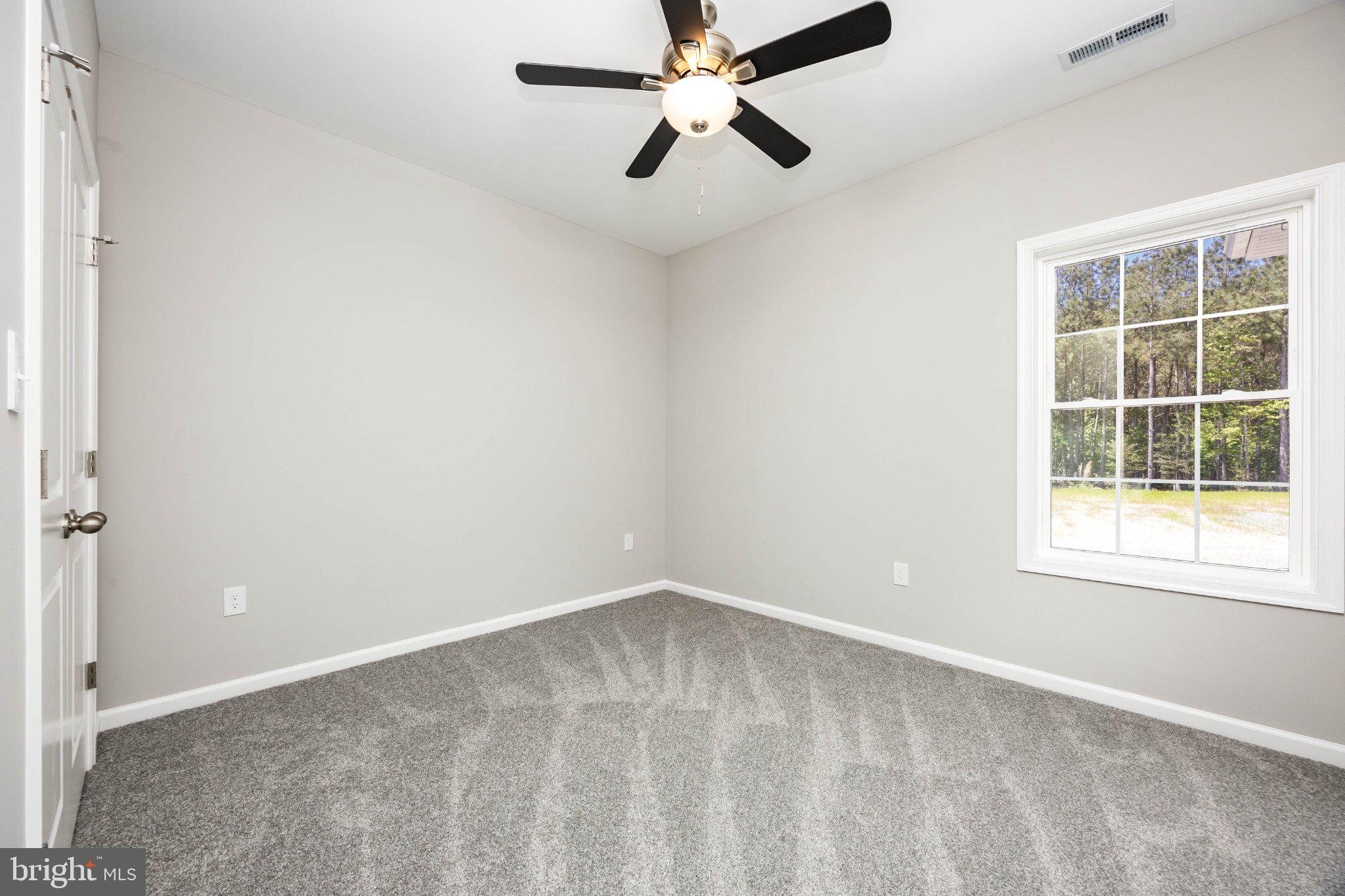 14949 Shiloh Church Road Laurel, DE 19956 - Photo 19 of 32 an empty room with a window and a fan