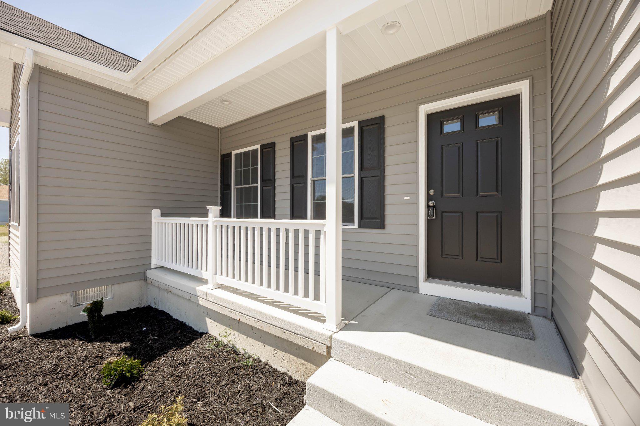 14949 Shiloh Church Road Laurel, DE 19956 - Photo 2 of 32 a porch with a chair
