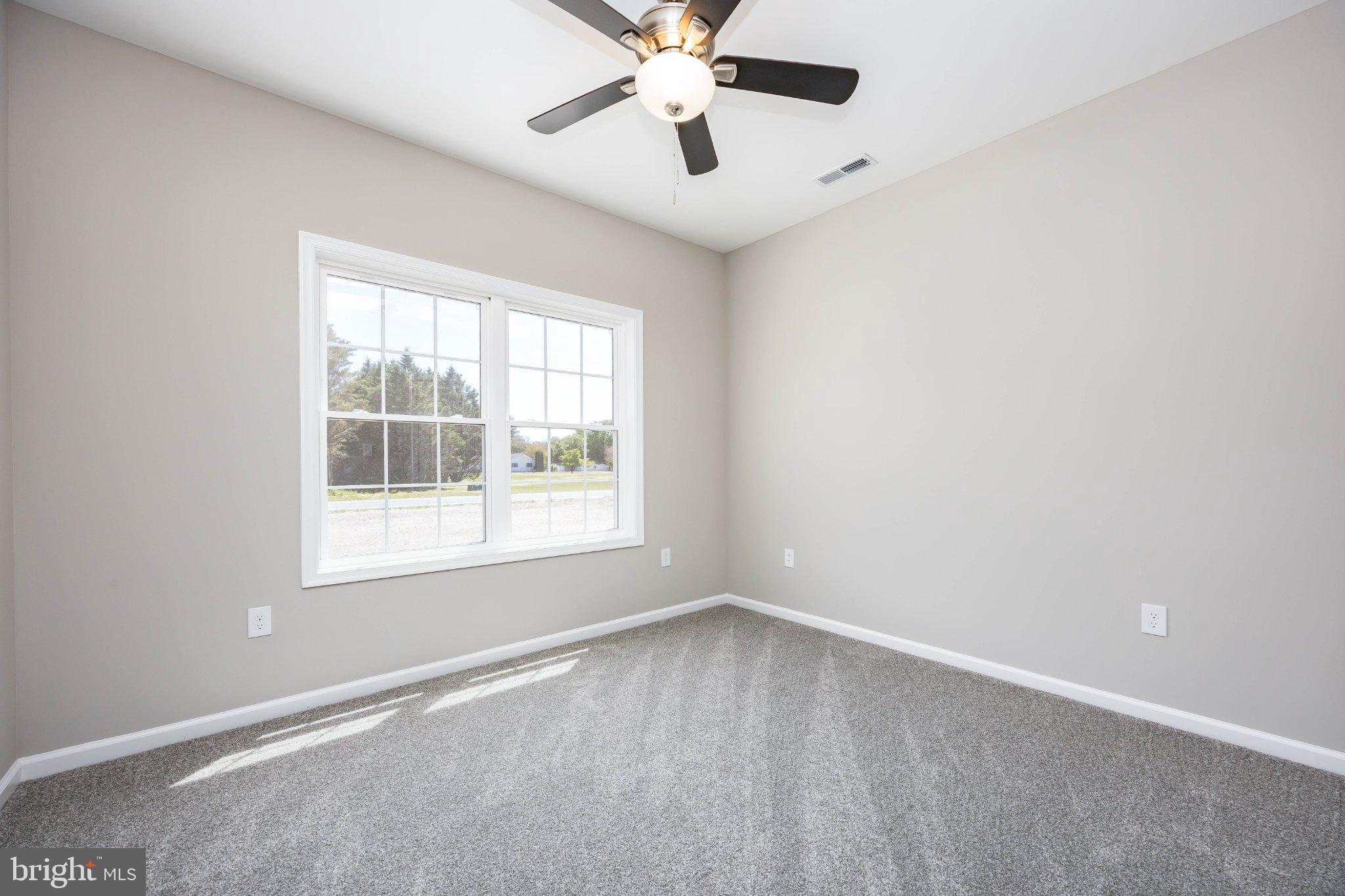 14949 Shiloh Church Road Laurel, DE 19956 - Photo 23 of 32 an empty room with a window and a fan