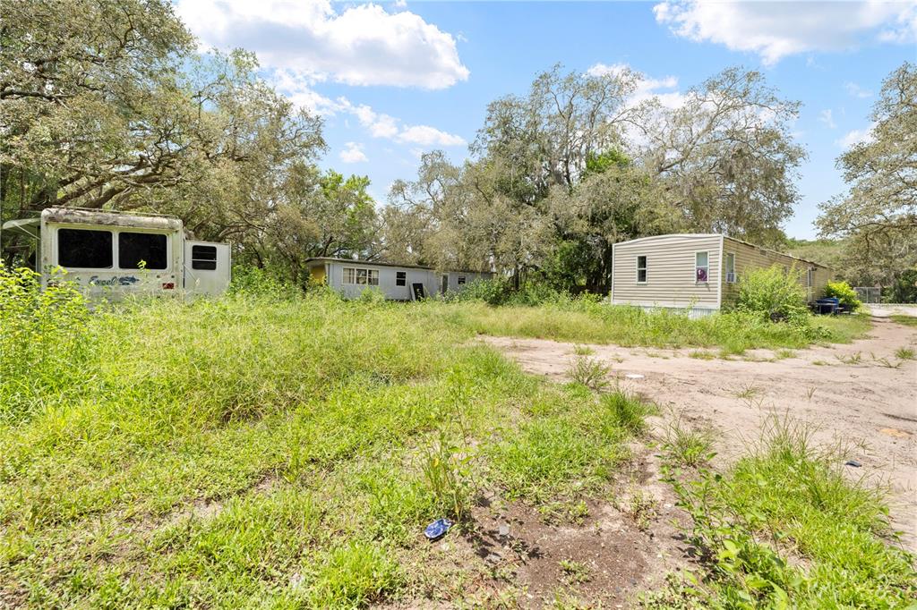 16710 Monteverde Drive Spring Hill, FL 34610 - Photo 10 of 16 a yellow house with lots of trees