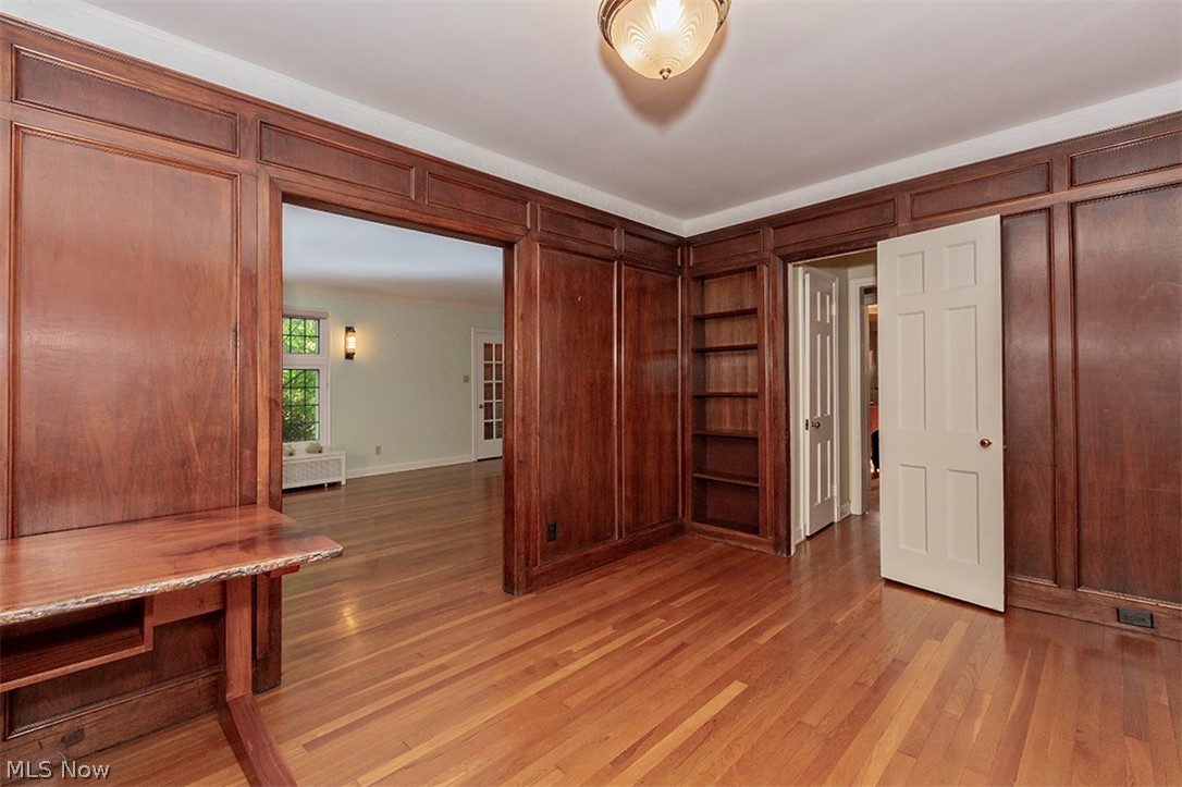 2830 East Overlook Road Cleveland, OH 44118 - Photo 12 of 32 Paneled Library or Office with corner bookcase. Note the lovely condition of the hardwood floors. White door leads to hallway towards the Kitchen.