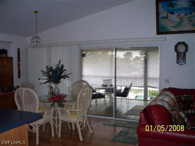 10684 Russell Road Bokeelia, FL 33922 - Photo 3 of 10 a view of a dining room with furniture window and outside view