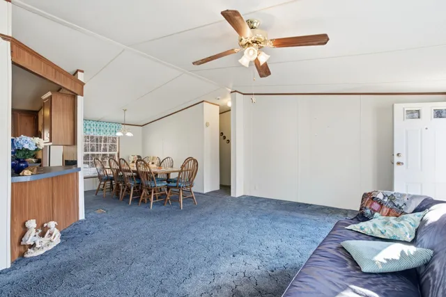 a view of a livingroom with furniture and a window