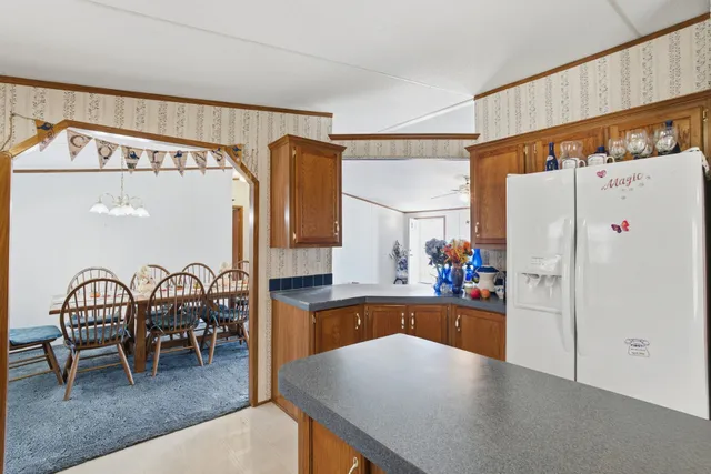 a kitchen with refrigerator and cabinets