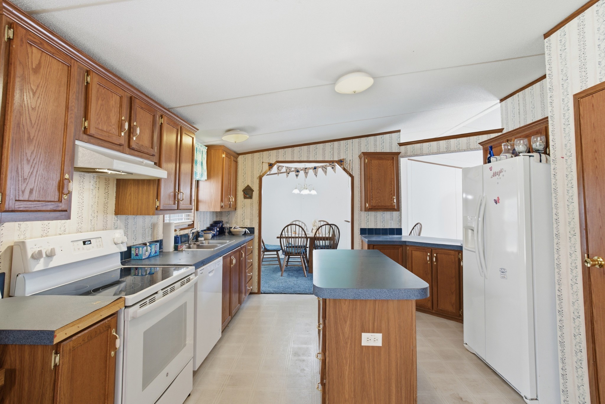 1700 Cumberland Valley Road Erin, TN 37061 - Photo 20 of 24 a kitchen with stainless steel appliances granite countertop a sink stove and refrigerator