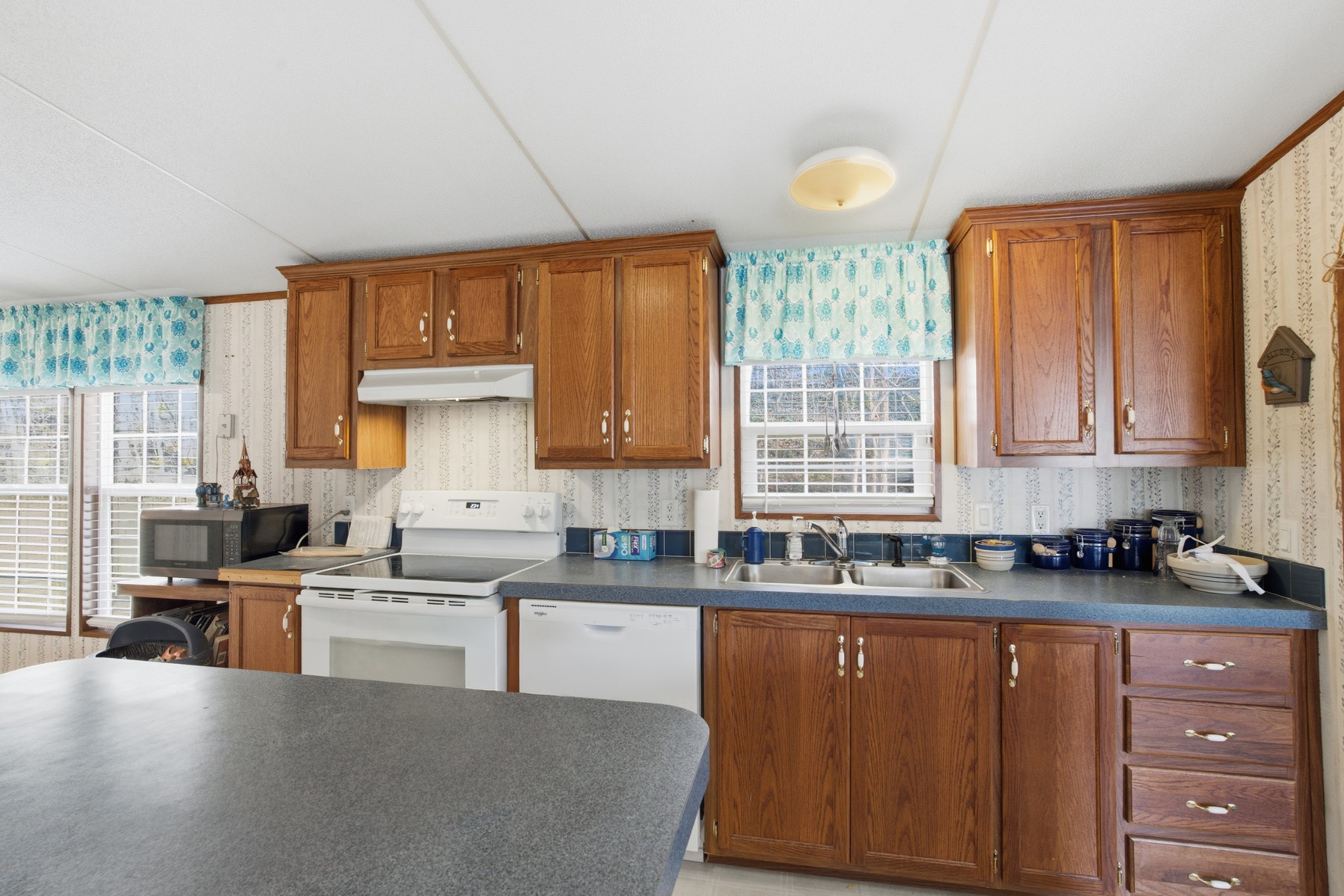 1700 Cumberland Valley Road Erin, TN 37061 - Photo 21 of 24 a kitchen with stainless steel appliances a sink a stove a refrigerator cabinets and a window