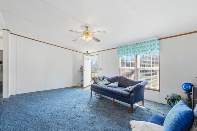 a living room with furniture and a dining table