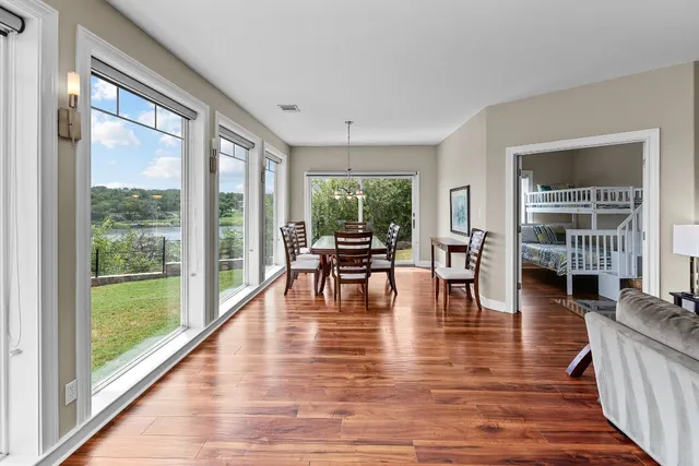 a living room with furniture and floor to ceiling windows