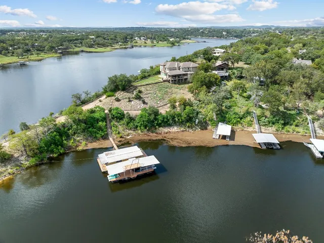 an aerial view of a house with a lake view