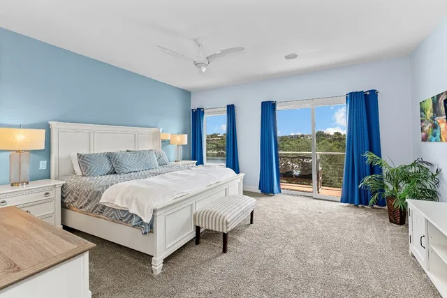 a spacious bedroom with a bed and a large window