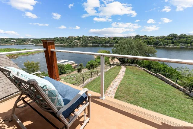 a view of swimming pool with a lake from a balcony