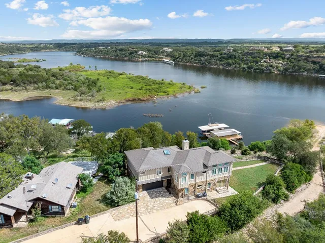 an aerial view of a house with garden space and lake view