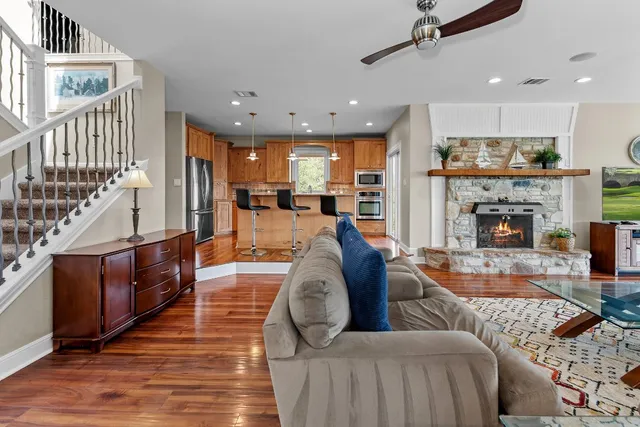 a living room with furniture wooden floor and a fireplace