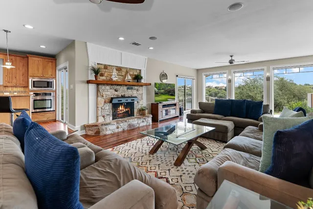 a living room with furniture fireplace and a large window