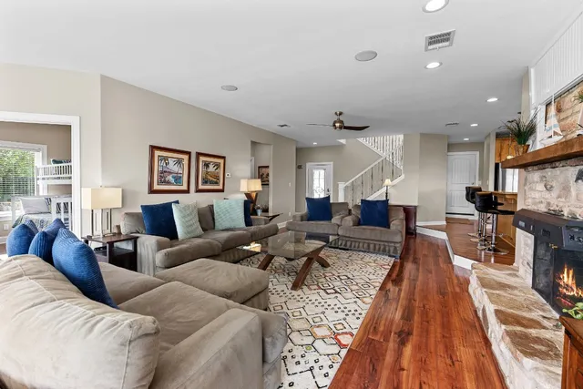 a living room with furniture wooden floor and a table