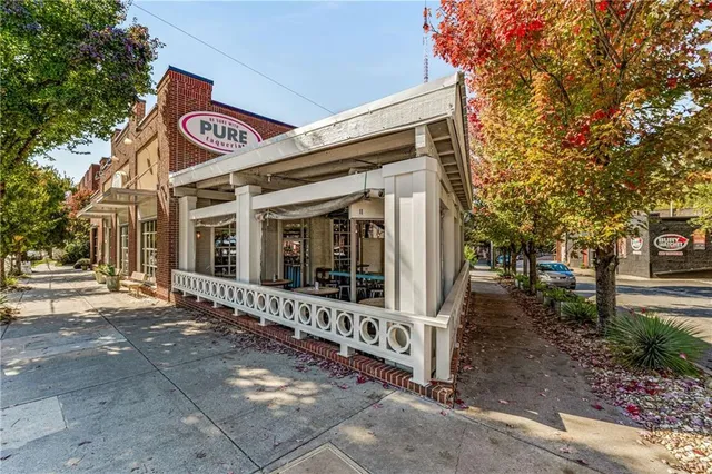 a view of a street with retail shops