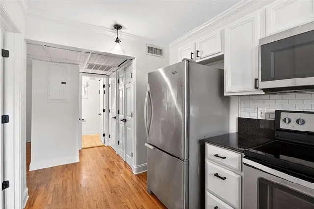 a kitchen with stainless steel appliances a refrigerator stove and sink