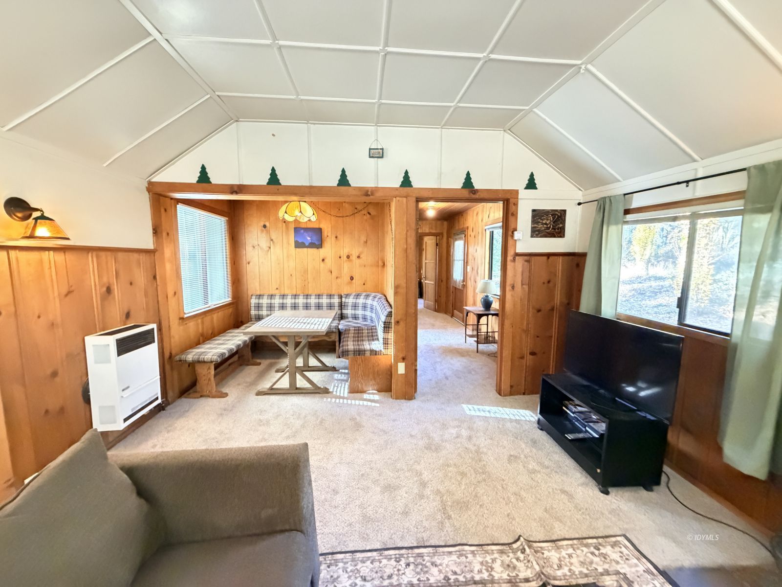 54059 Montgomery Idyllwild, CA 92549 - Photo 6 of 24 a living room with furniture a flat screen tv and a large window