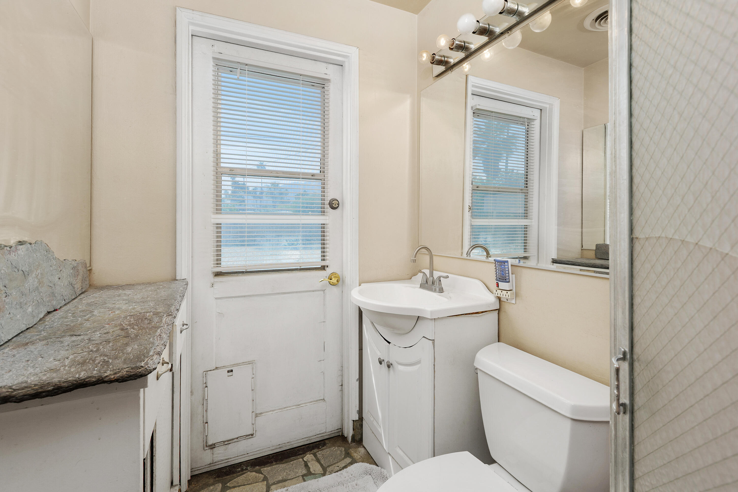 1077 South Riverside Drive Palm Springs, CA 92264 - Photo 27 of 35 a bathroom with a granite countertop toilet and sink