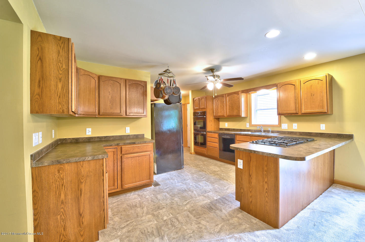 274 Trenton Lakewood Road Cream Ridge, NJ 08514 - Photo 15 of 31 a kitchen with stainless steel appliances granite countertop a stove a sink dishwasher and a refrigerator with wooden cabinets