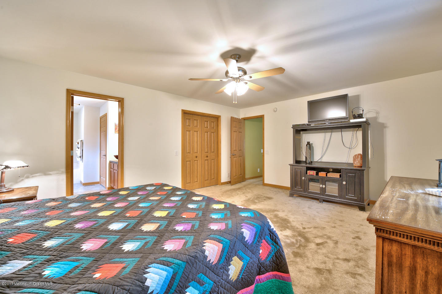 274 Trenton Lakewood Road Cream Ridge, NJ 08514 - Photo 19 of 31 a bedroom with a bed and a chandelier