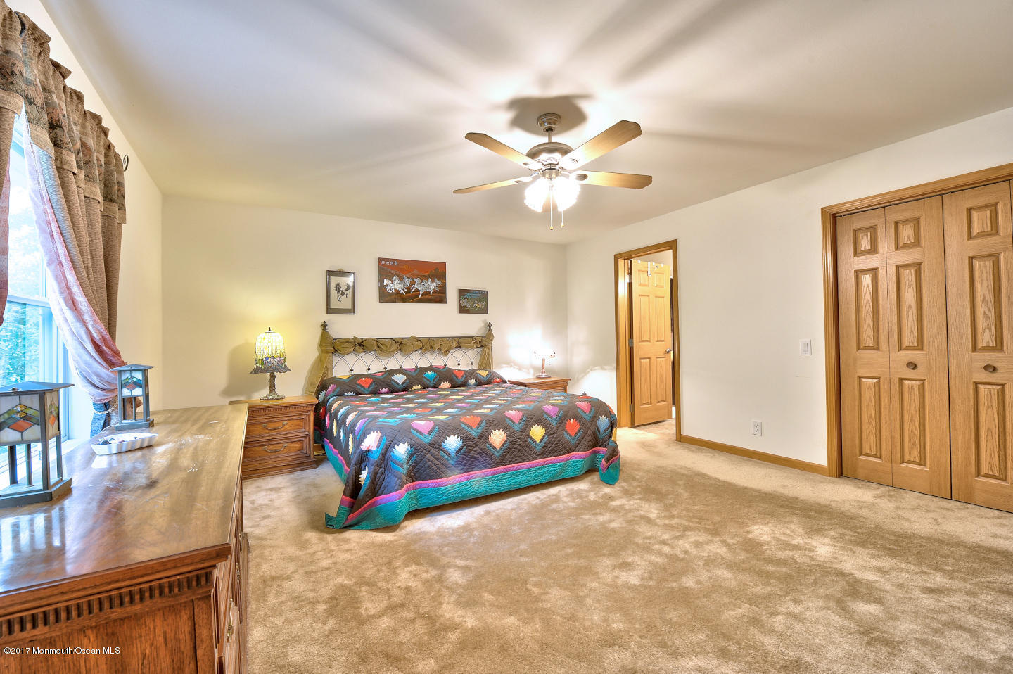 274 Trenton Lakewood Road Cream Ridge, NJ 08514 - Photo 20 of 31 a bedroom with a large bed and a chandelier