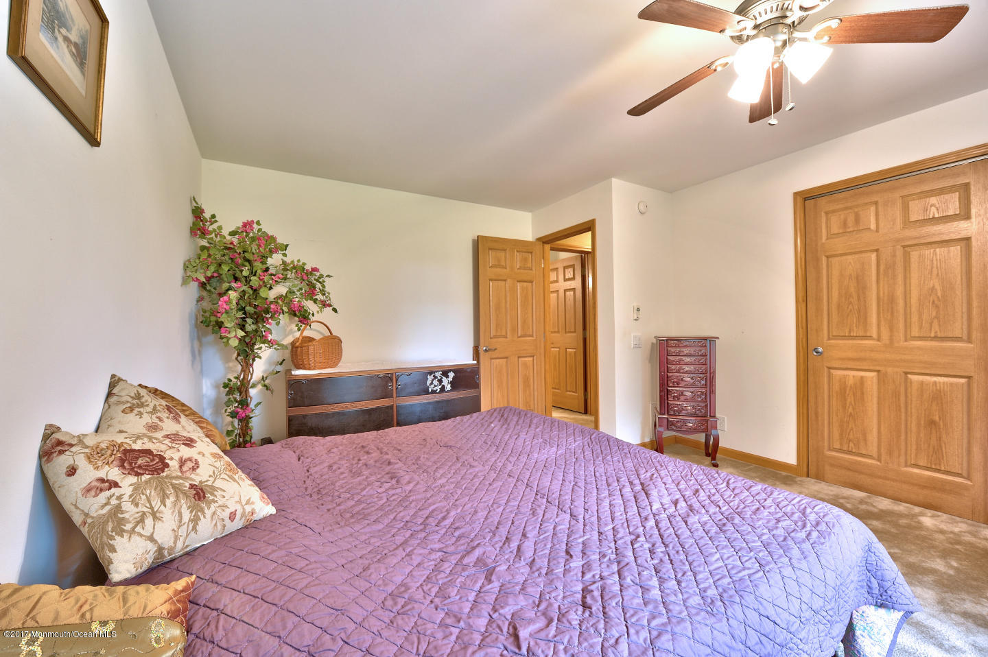 274 Trenton Lakewood Road Cream Ridge, NJ 08514 - Photo 26 of 31 a bedroom with a large bed and a chandelier