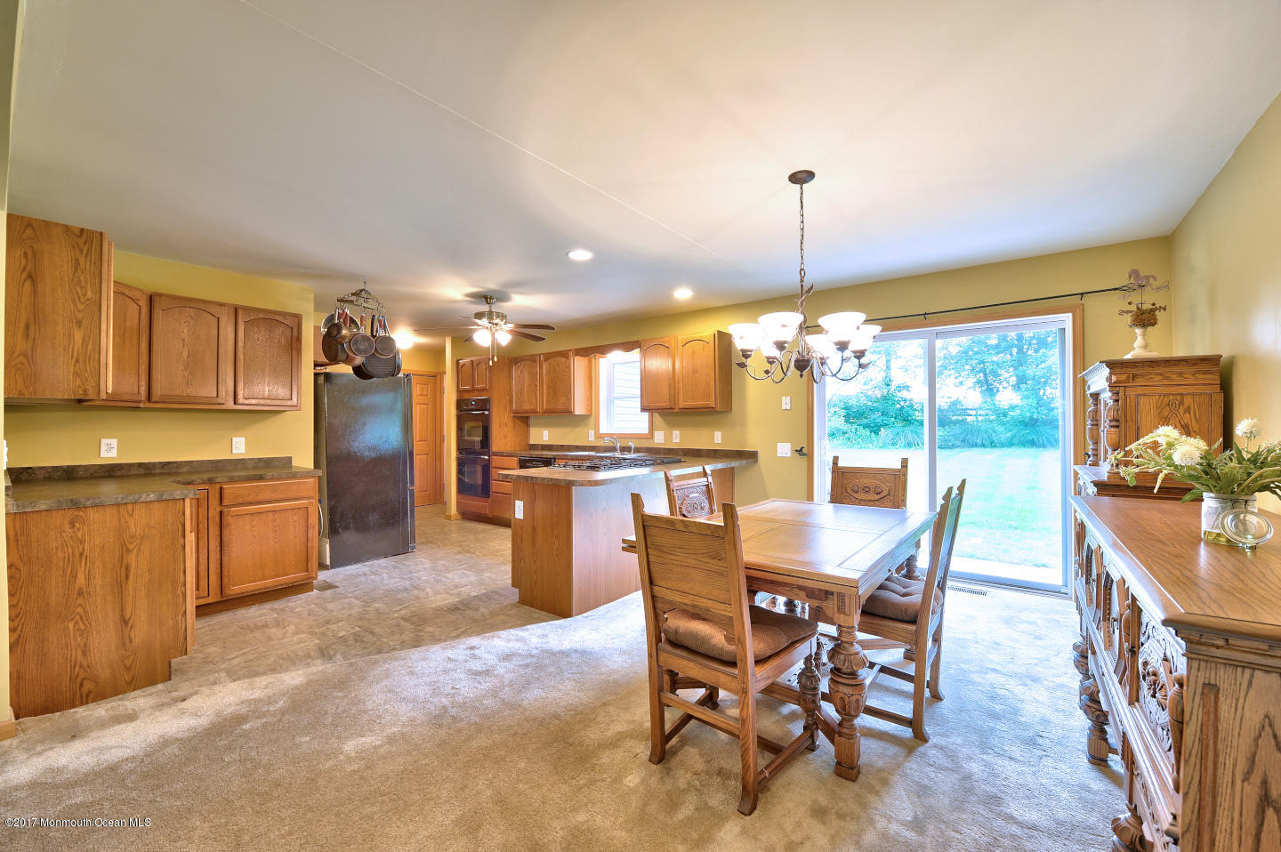 274 Trenton Lakewood Road Cream Ridge, NJ 08514 - Photo 9 of 31 a dining area with a table chairs and a kitchen view