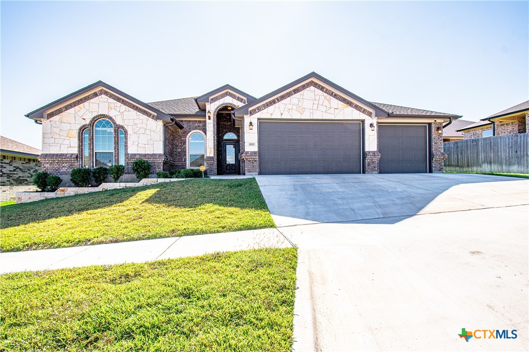 a front view of a house with a yard and garage