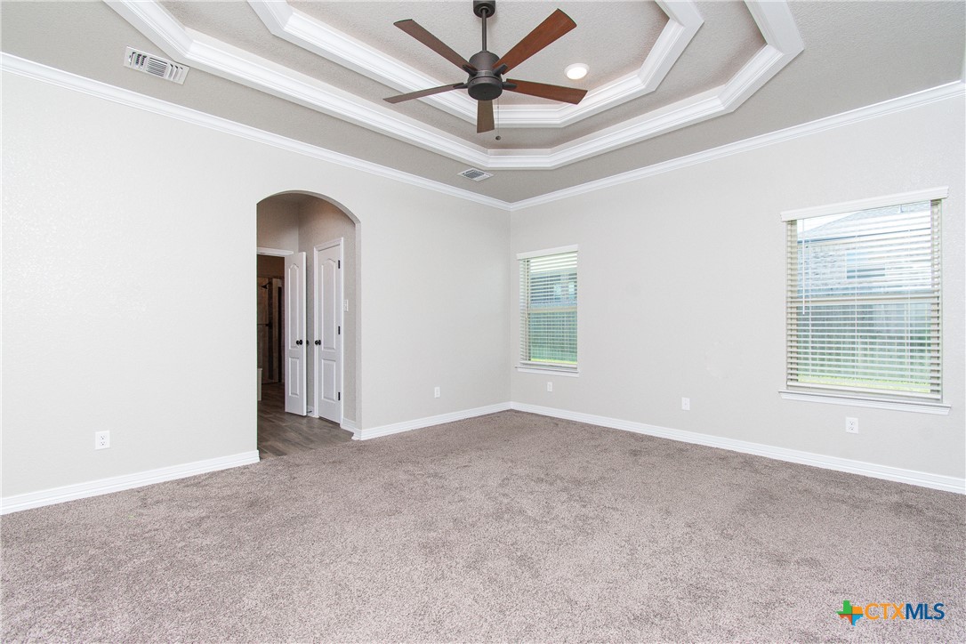 8101 Tenley Way Killeen, TX 76542 - Photo 14 of 29 an empty room with chandelier fan and windows