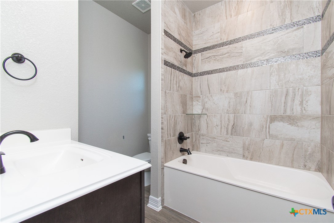 8101 Tenley Way Killeen, TX 76542 - Photo 25 of 29 a bathroom with a tub a sink and a shower