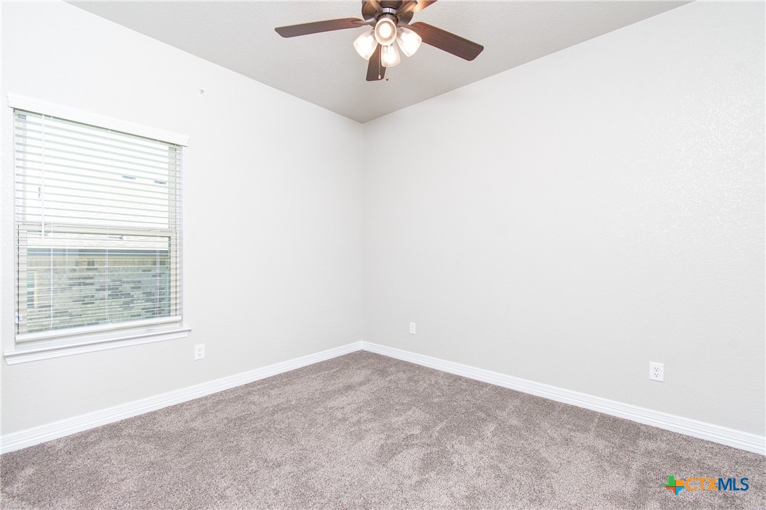 8101 Tenley Way Killeen, TX 76542 - Photo 28 of 29 an empty room with a window and a ceiling fan