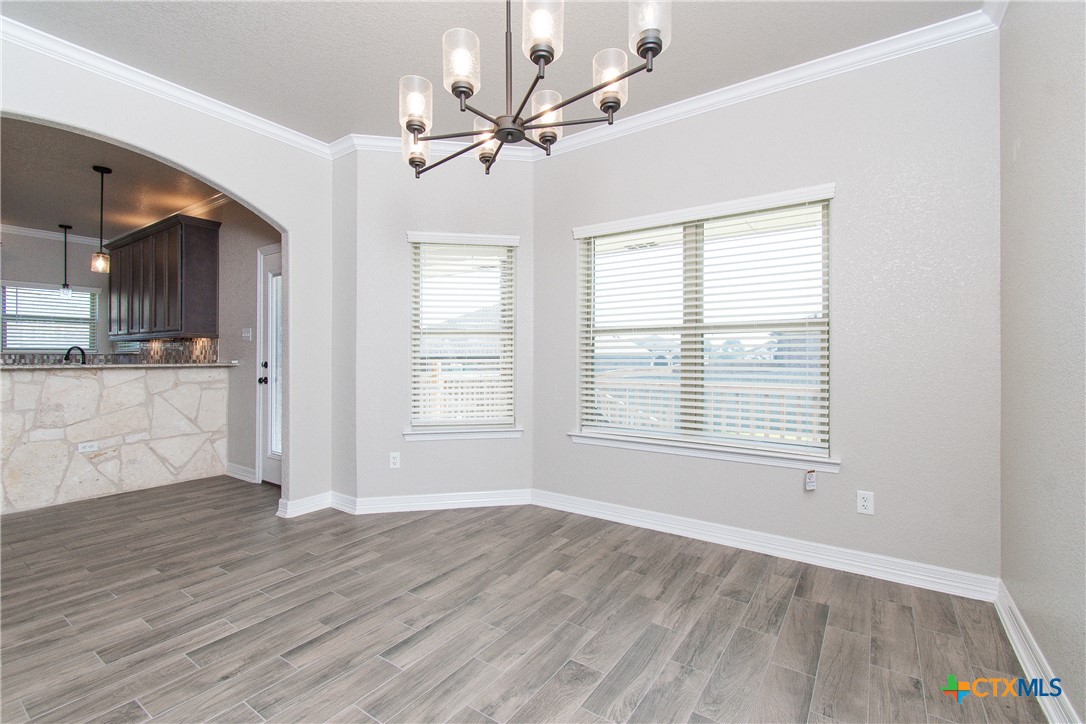 8101 Tenley Way Killeen, TX 76542 - Photo 7 of 29 a view of an empty room with a window and wooden floor