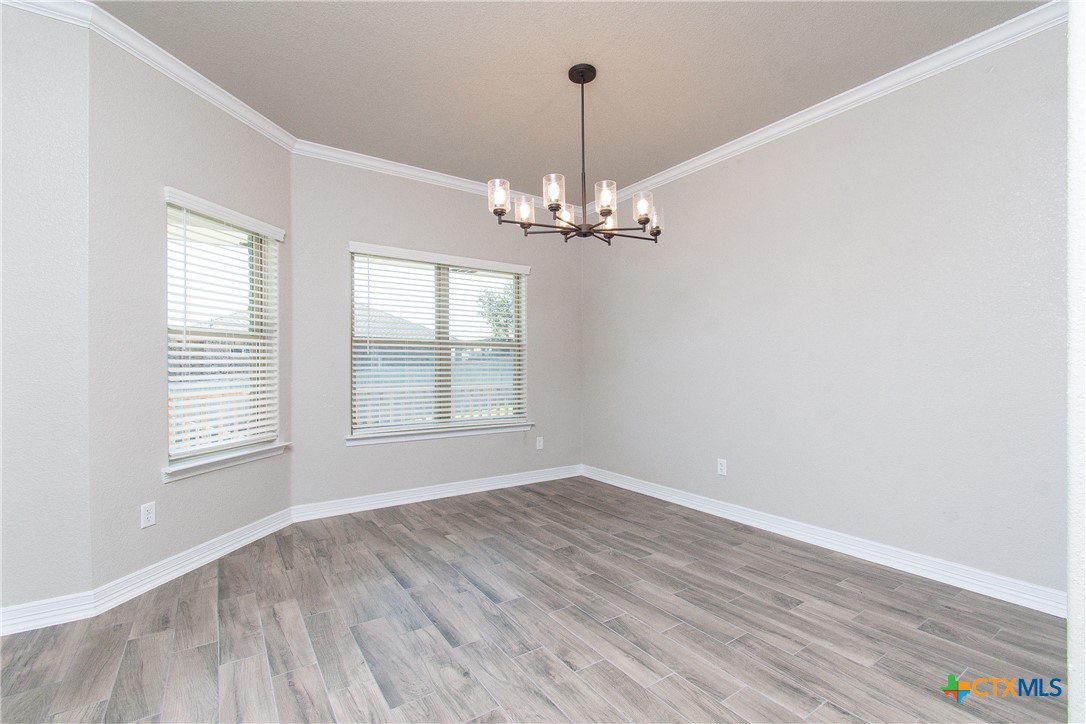 8101 Tenley Way Killeen, TX 76542 - Photo 8 of 29 wooden floor in an empty room with a window