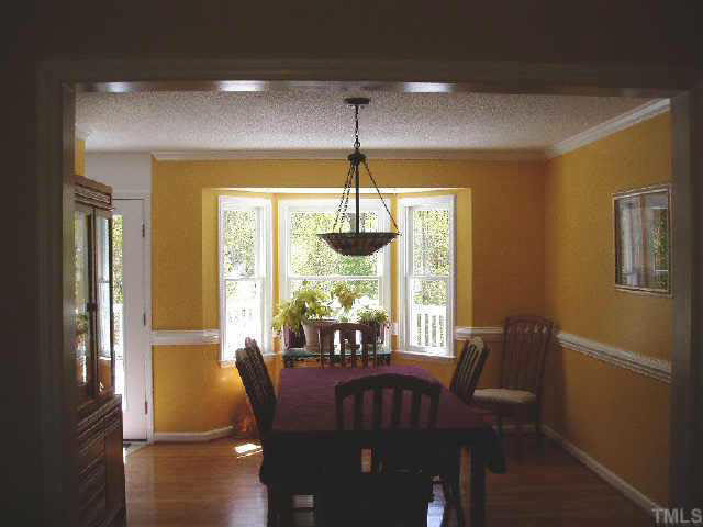 612 Trunecek Circle Raleigh, NC 27603 - Photo 4 of 9 a view of a dining room with furniture window and wooden floor