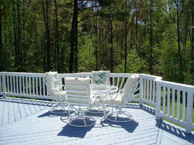 612 Trunecek Circle Raleigh, NC 27603 - Photo 7 of 9 a view of balcony with wooden floor and outdoor seating