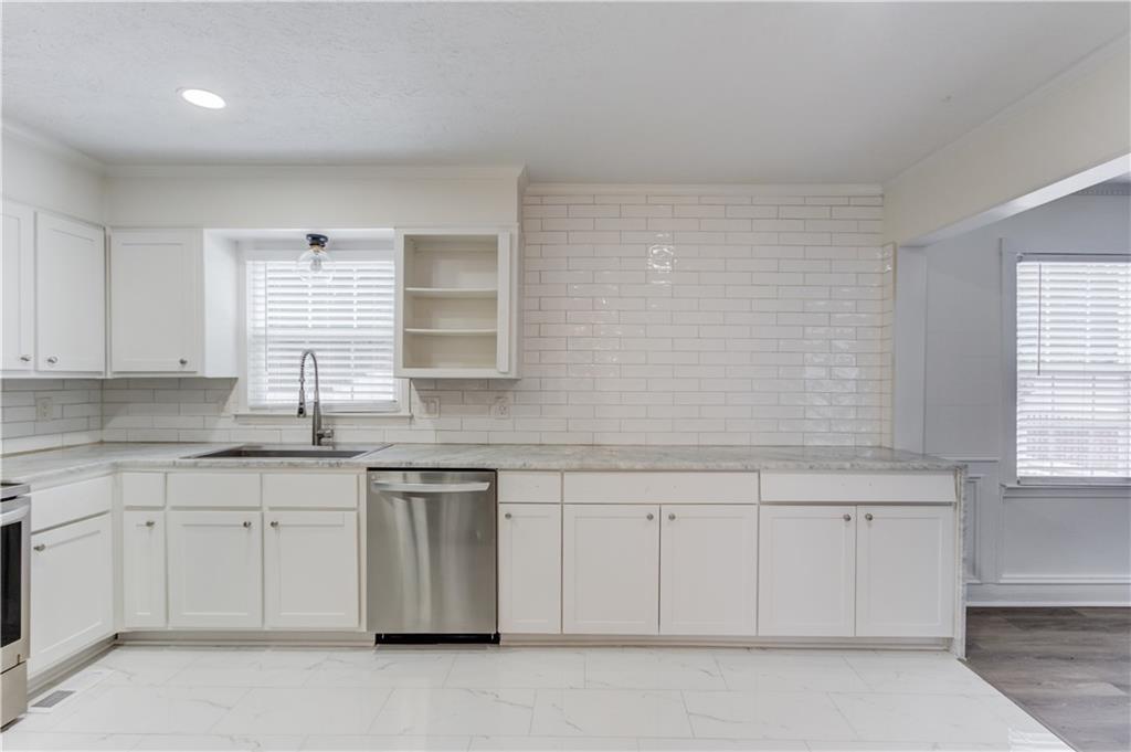 313 Summit Ridge Drive Lawrenceville, GA 30046 - Photo 14 of 42 a kitchen with white cabinets and sink