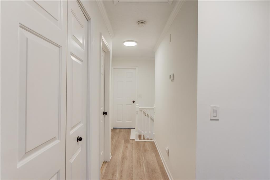 313 Summit Ridge Drive Lawrenceville, GA 30046 - Photo 18 of 42 a view of a hallway with wooden floor