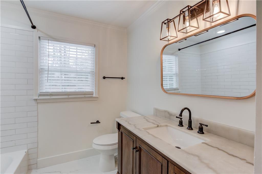 313 Summit Ridge Drive Lawrenceville, GA 30046 - Photo 23 of 42 a bathroom with a granite countertop sink a toilet and a mirror