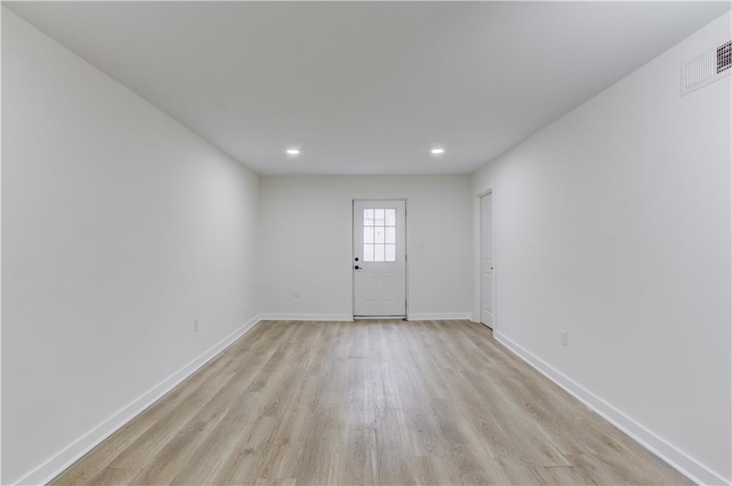 313 Summit Ridge Drive Lawrenceville, GA 30046 - Photo 29 of 42 an empty room with wooden floor and windows