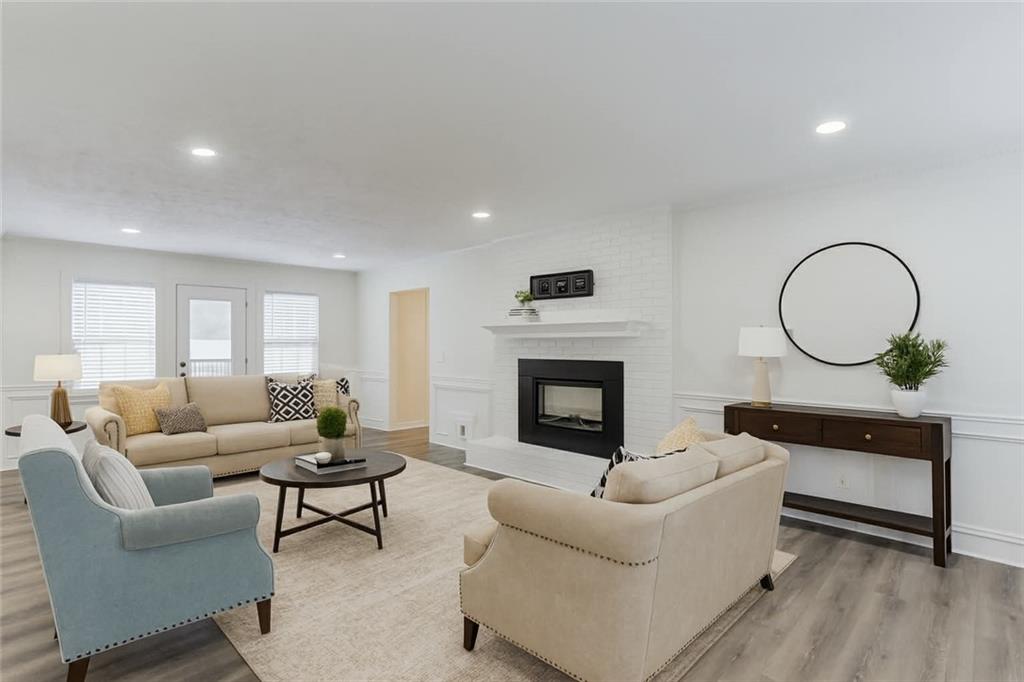 313 Summit Ridge Drive Lawrenceville, GA 30046 - Photo 3 of 42 a living room with furniture a fireplace a rug and a window