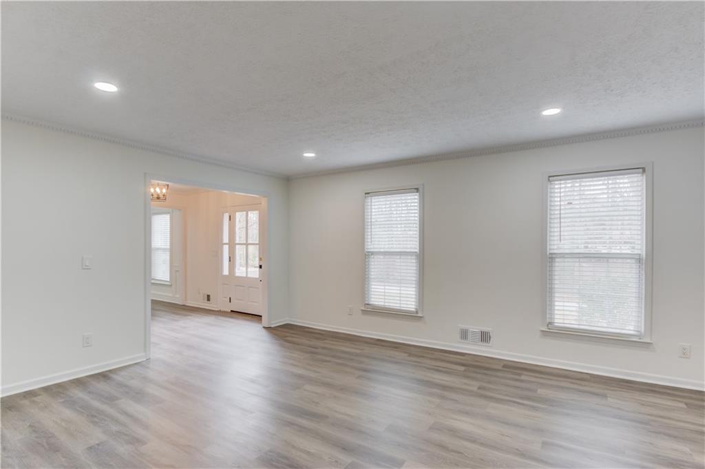 313 Summit Ridge Drive Lawrenceville, GA 30046 - Photo 9 of 42 an empty room with wooden floor and windows