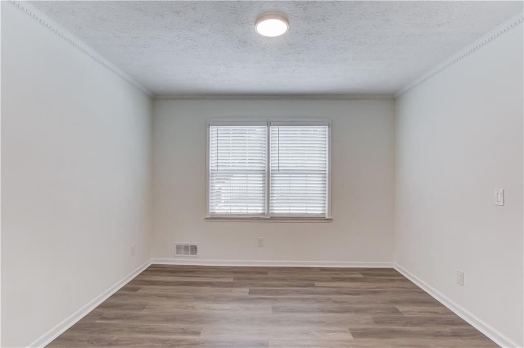 313 Summit Ridge Drive Lawrenceville, GA 30046 - Photo 10 of 42 an empty room with wooden floor and windows