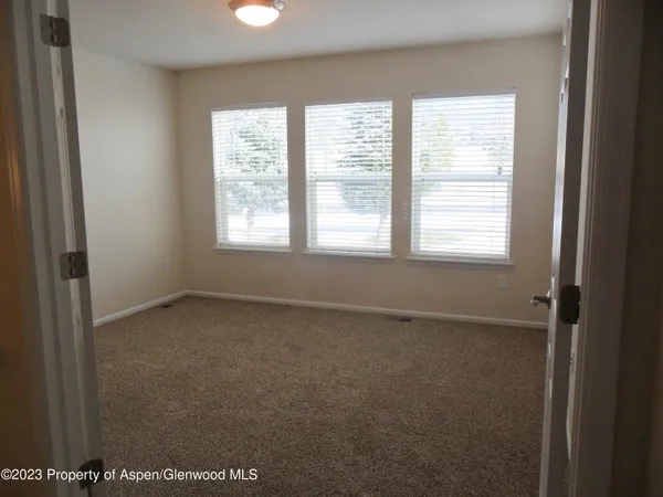 a view of an empty room with a window