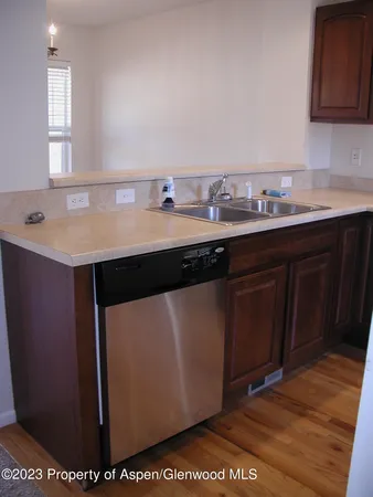 a kitchen with a sink cabinets and wooden floor