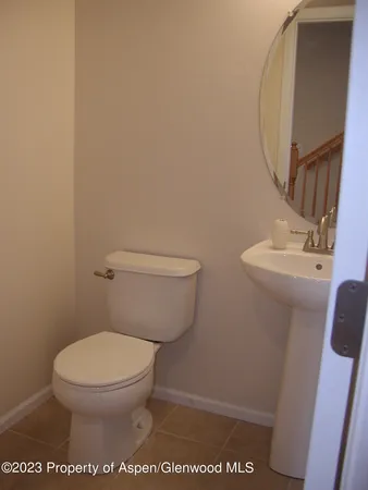 a white toilet sitting next to a white sink