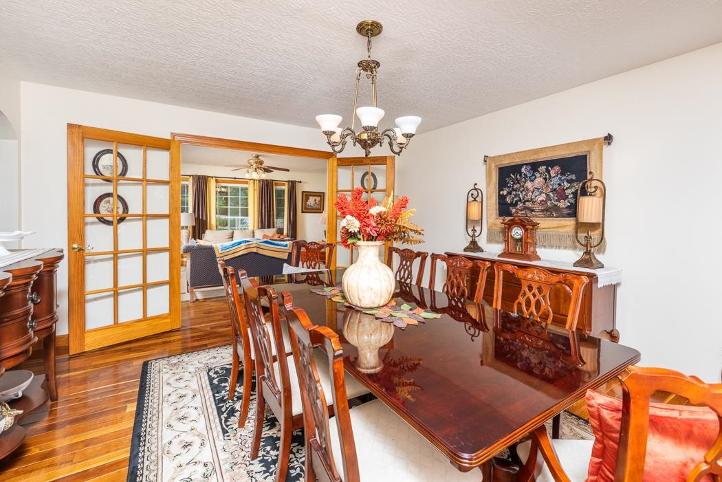 170 Old Back Road Raphine, VA 24472 - Photo 34 of 66 a view of a dining room with furniture a chandelier and wooden floor