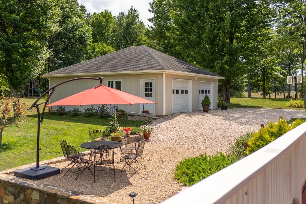 170 Old Back Road Raphine, VA 24472 - Photo 56 of 66 a view of a patio with a table chairs under an umbrella